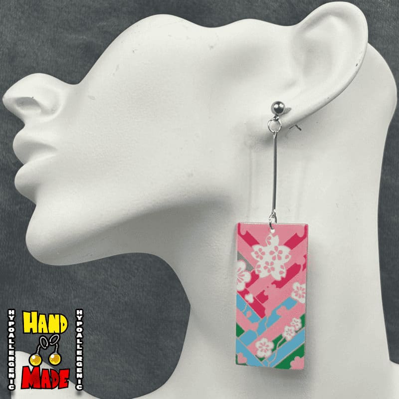 Acrylic Cherry Blossom Hanafuda Anime Earrings shown on a white molded display, with bright pink cherry blossom acrylic charms and silver dropped posts.