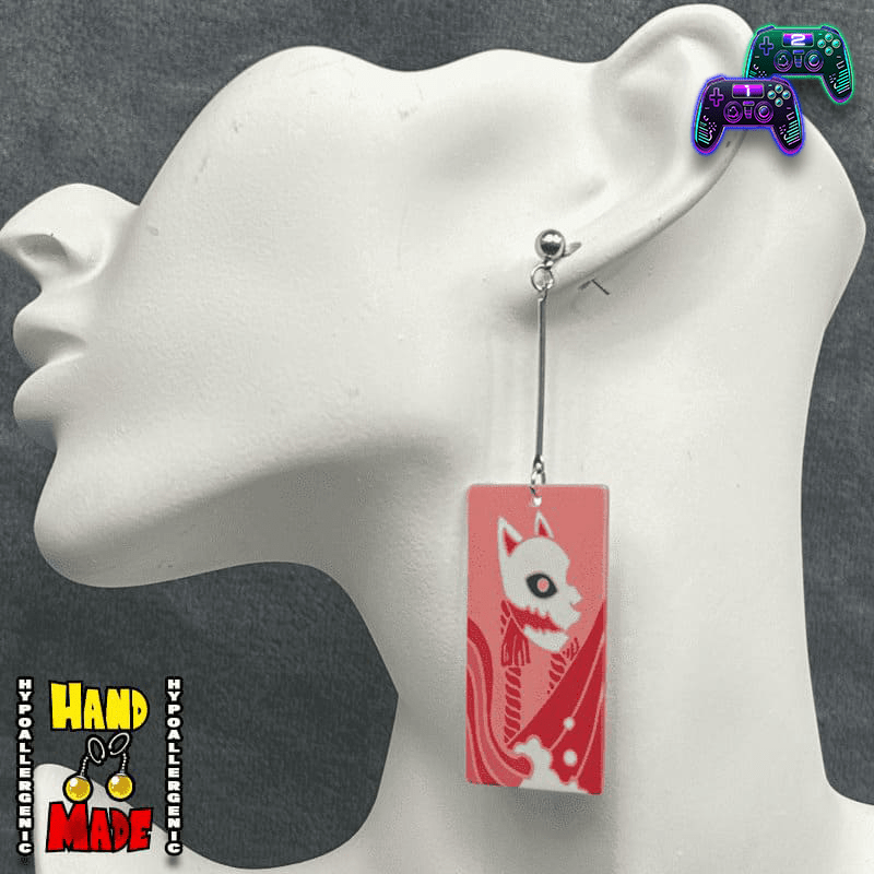 Large Acrylic Fox Mask Hanafuda Anime Earrings displayed on a white earring stand, featuring a soft salmon-colored fox mask charm on silver dropped posts.
