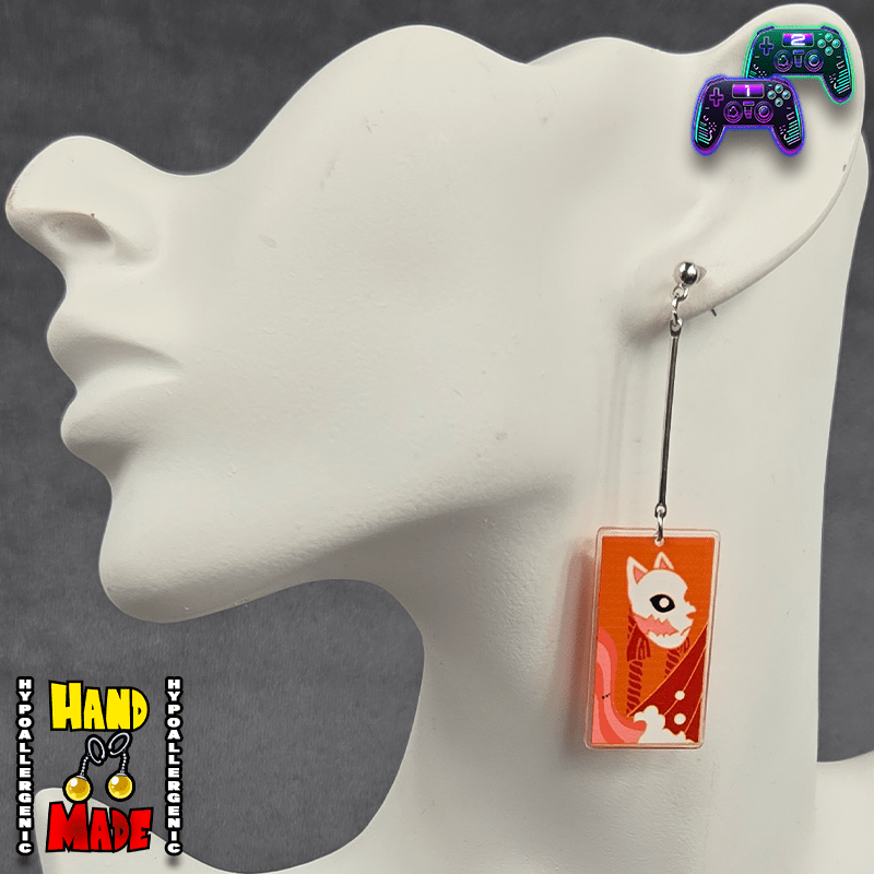 Small Acrylic Fox Mask Hanafuda Anime Earrings displayed on a white earring stand, featuring a vibrant orange-toned fox mask charm on silver dropped posts.