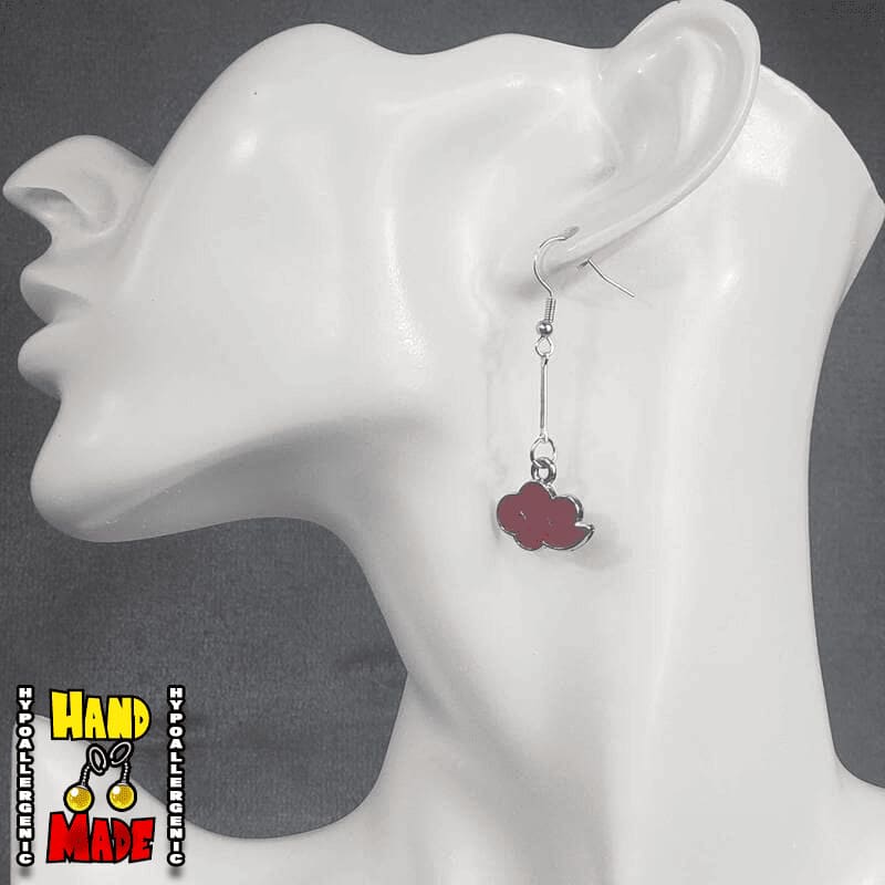 A pair of red cloud charms, dangling from a silver extender, attached to a silver French hook, displayed on a mannequin head.