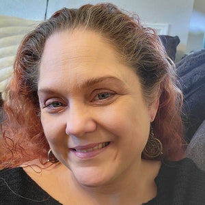 Model wearing Alchemist Circle Anime Earrings with cutout metal alchemist circle charms and silver French hooks.