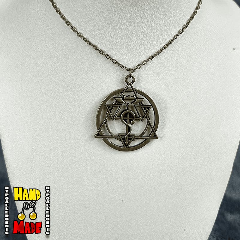 A necklace with a metallic bronze pendant featuring a complex alchemical symbol from the Full Metal Alchemist series, displayed on a mannequin