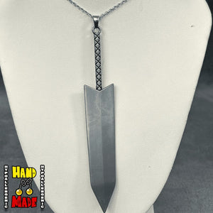 A silver-tone metal charm designed to resemble a greatsword with a braided hilt, displayed on a mannequin bust with a hypoallergenic silver-tone chain.