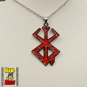 A red and black Berserk Brand of Sacrifice necklace pendant on a silver chain, displayed against a white background.