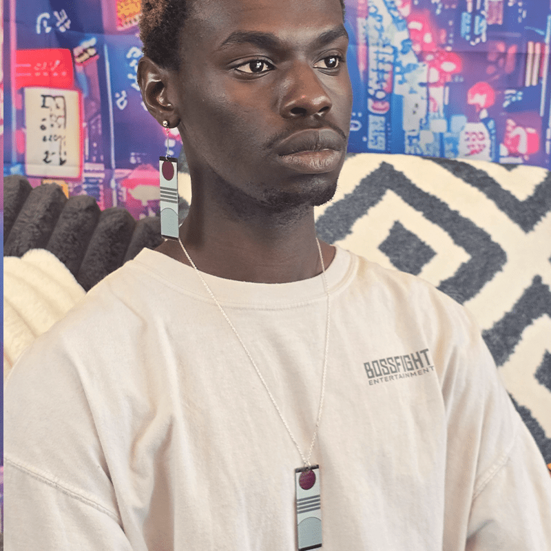 Person wearing the Acrylic Triple Stripe Rising Sun Hanafuda Anime Necklace, showing the striped acrylic charm and sleek silver chain on the chest.