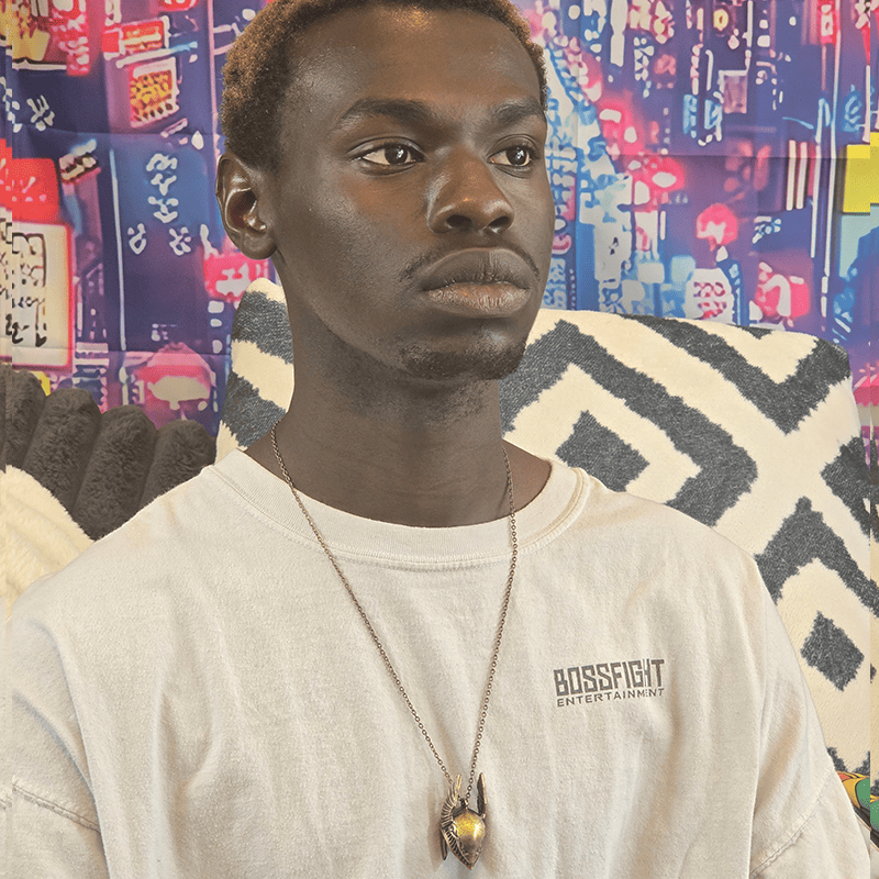 Model wearing Golden Warrior Helmet Gaming Necklace with detailed gold helmet charm on a gold chain.