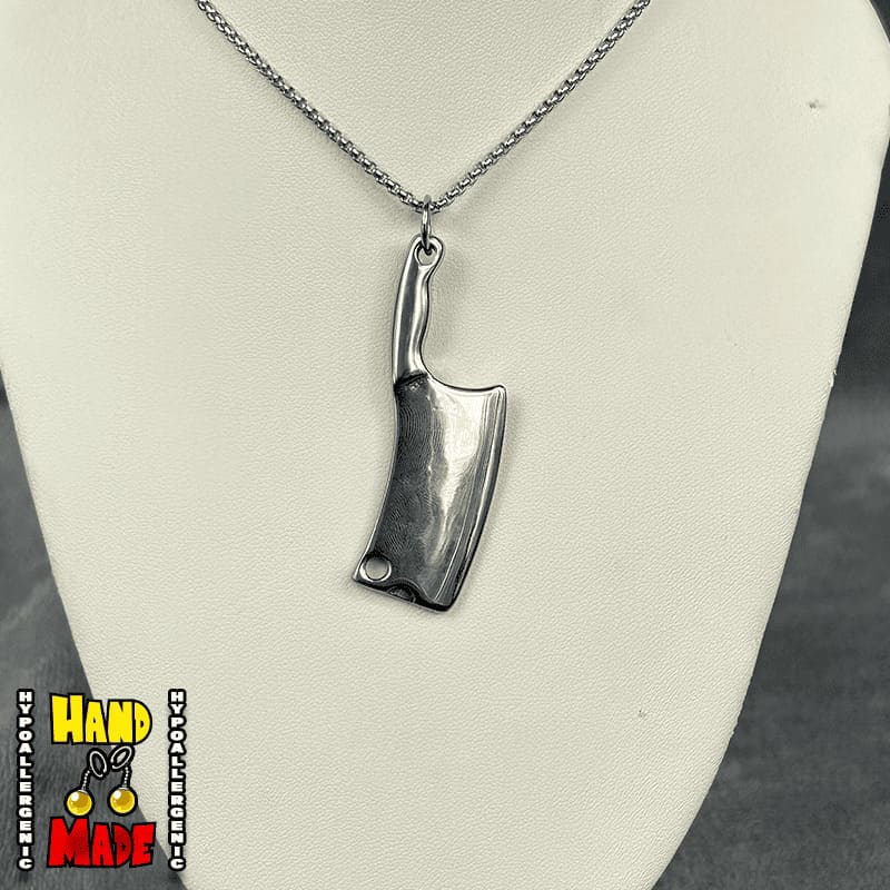 A silver-tone metal hatchet charm attached to a hypoallergenic silver-tone chain, displayed on a white mannequin.