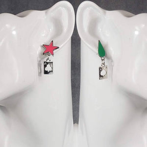 A pair of earrings featuring a pink star and a green teardrop, each attached to a silver-tone stud post, with the star having a ace of clubs cutout and the teardrop having a ace of hearts cutout.