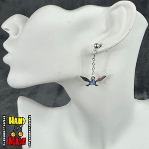 Silver dangle Navi Earrings with bright blue charm in the center of the fairy on silver dropped posts