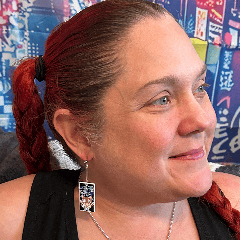 Model wearing Metal Boar Mask Hanafuda Anime Earrings with metal boar mask charms and sterling silver dropped posts.