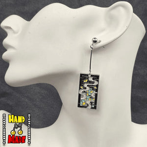 Metal Rivers Hanafuda Anime Earrings displayed on a white molded stand with polished river motif metal charms and silver dropped posts.