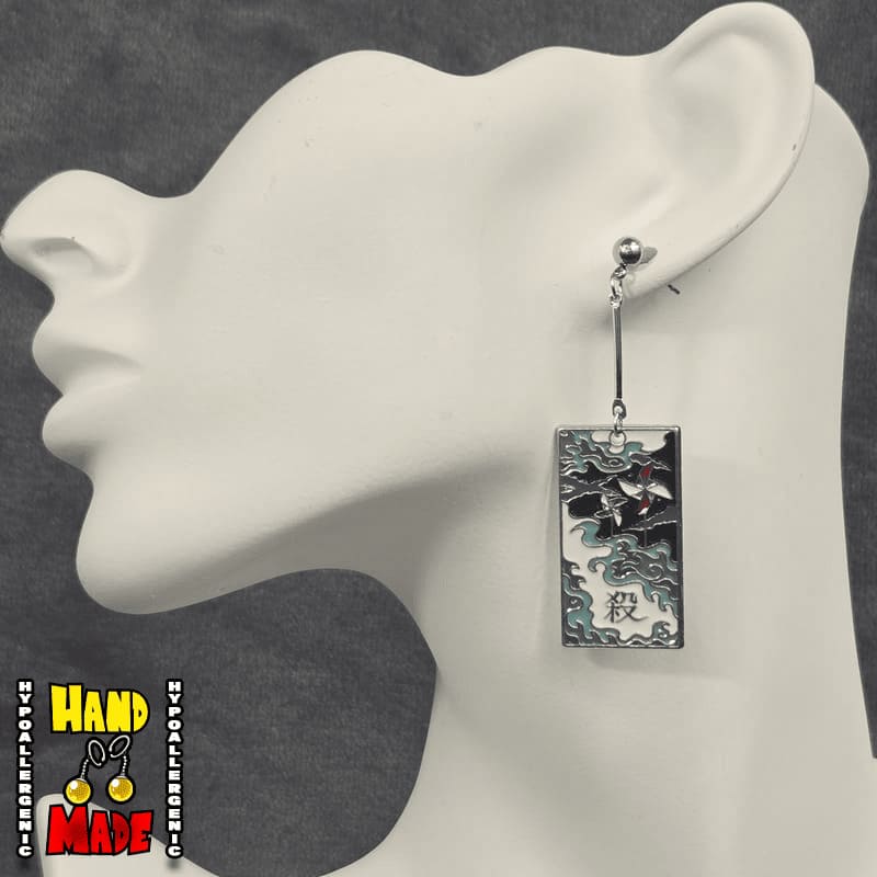 Metal Windmills Hanafuda Anime Earrings displayed on a white molded stand, with polished windmill metal charms and gold dropped posts.