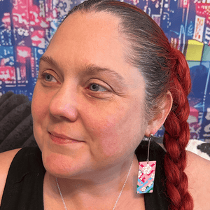 Model wearing the Acrylic Cherry Blossom Hanafuda Anime Earrings, featuring vivid pink charms and sterling silver dropped posts for a playful, elegant look.