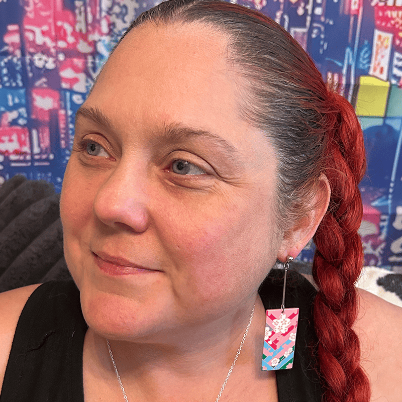 Model wearing the Acrylic Cherry Blossom Hanafuda Anime Earrings, featuring vivid pink charms and sterling silver dropped posts for a playful, elegant look.