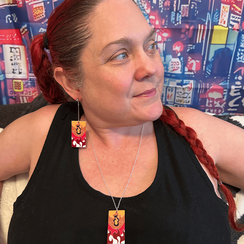 Model wearing the Pure Flames version of the Acrylic Fire Breathing Hanafuda Anime Necklace, showcasing a vivid flame design on a silver chain.
