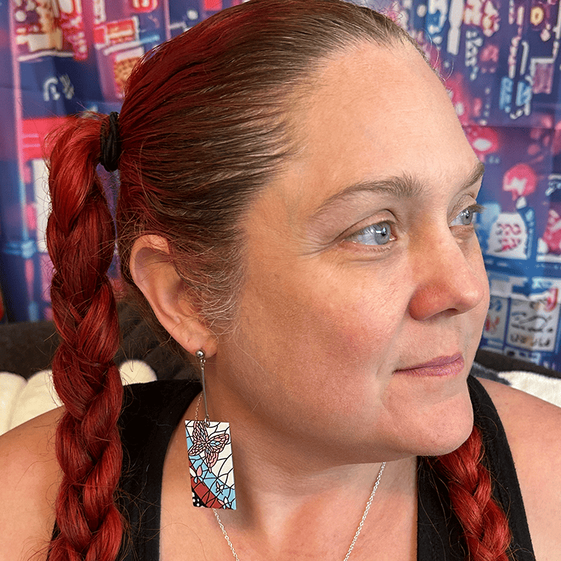 Model wearing the Acrylic Mosaic Butterfly Hanafuda Anime Earrings, with butterfly-inspired acrylic charms and sleek silver dropped posts.