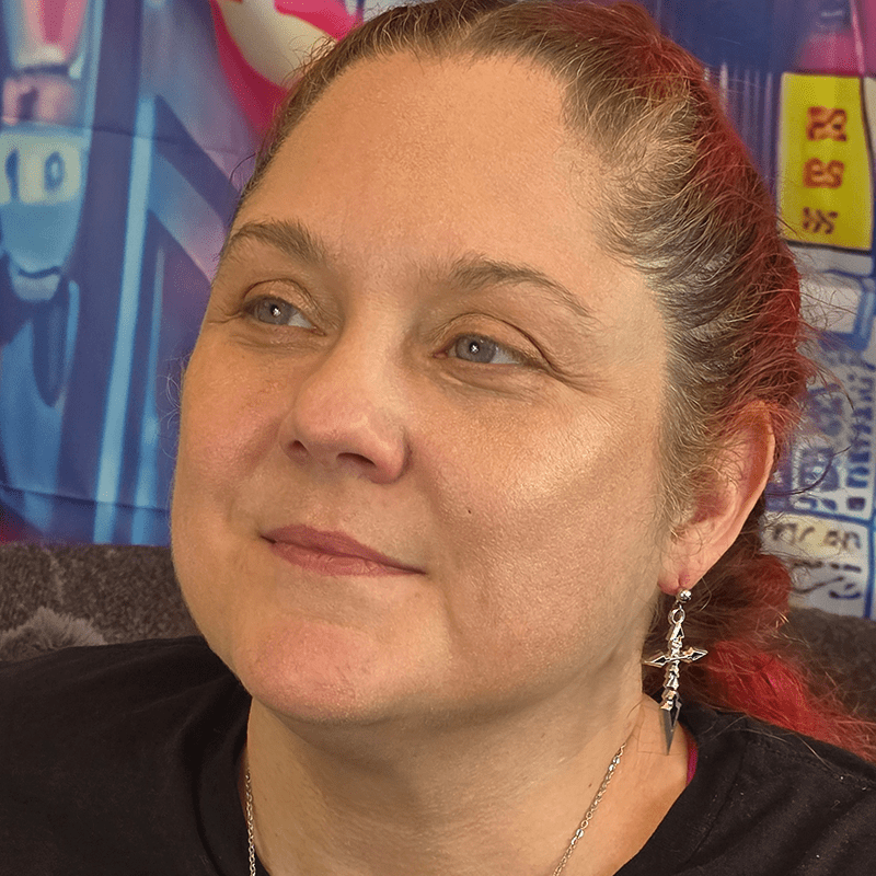 Model wearing Silver Cross Anime Earrings with polished silver cross charms and sterling silver dropped posts.