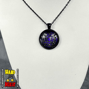 A black necklace with a purple domed acrylic pendant featuring a pentacle design, displayed on a mannequin.