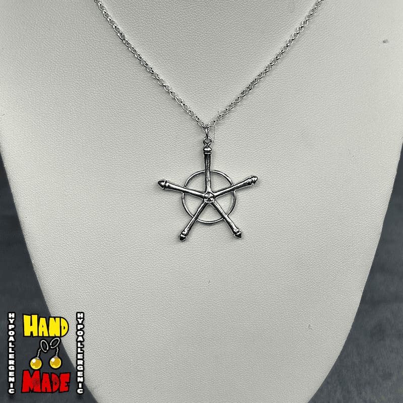 A silver necklace with a charm resembling a ship's wheel, displayed on a mannequin's neck.