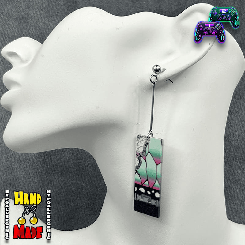 A pair of Acrylic Shinobu Hanafuda Earrings displayed on a mannequin head, featuring vibrant colors and Japanese card designs.