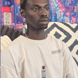 Person wearing the Acrylic Triple Stripe Rising Sun Hanafuda Anime Necklace, showing the striped acrylic charm and sleek silver chain on the chest.
