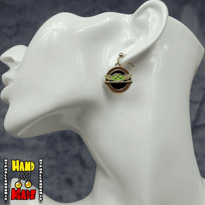 Handmade Golden Space Child Gaming Earrings featuring golden space child charm with gold dropped posts.