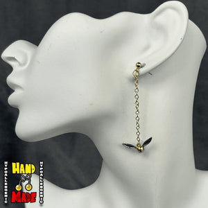 Handmade Golden Winged Orb Fantasy Earrings featuring golden winged orb charms with gold dropped posts.