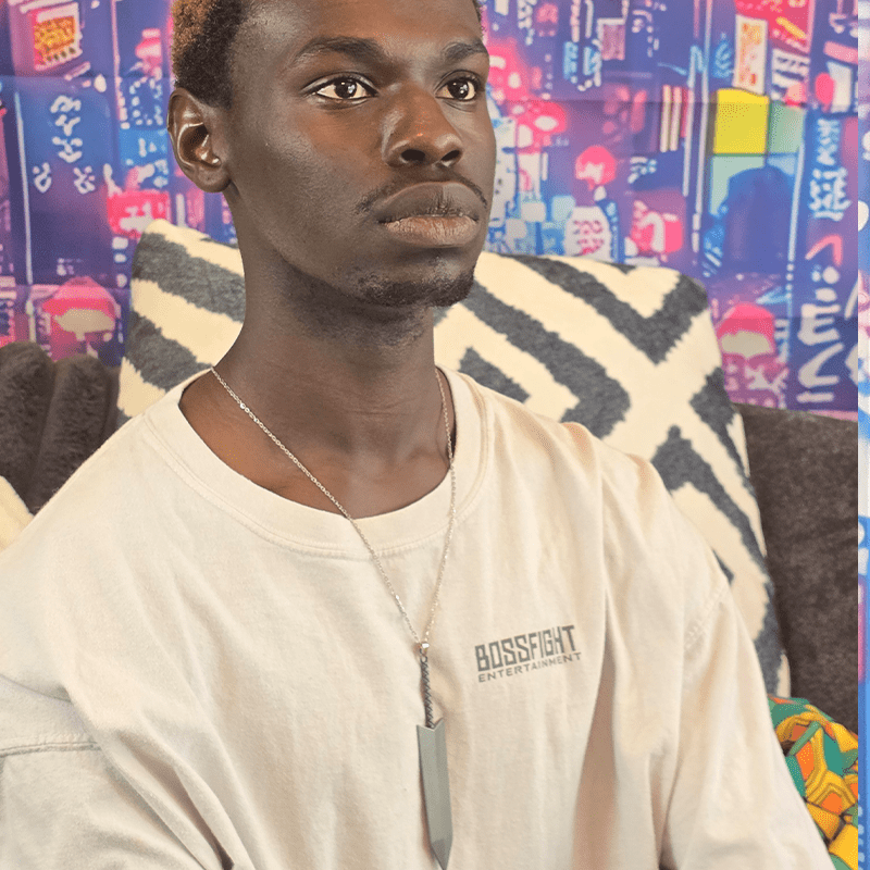 Model wearing Greatsword Anime Necklace with oversized silver greatsword charm on a silver chain.