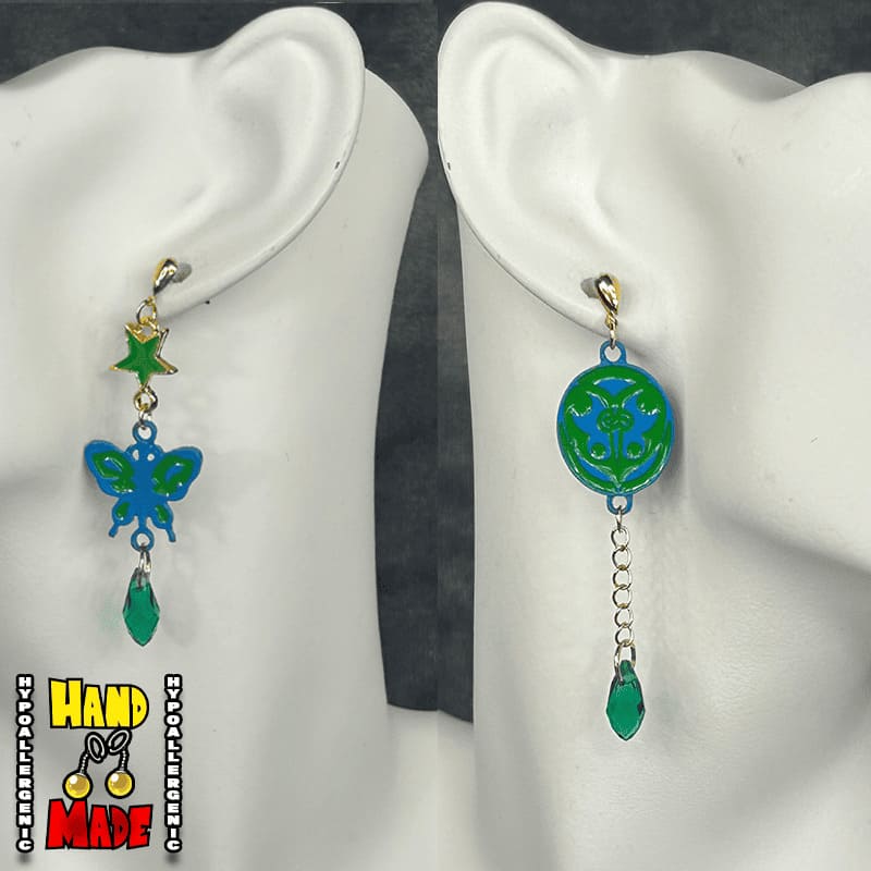 Handmade Ladybug and Scarab Anime Earrings featuring butterfly, scarab, and star charms with green bead accents.