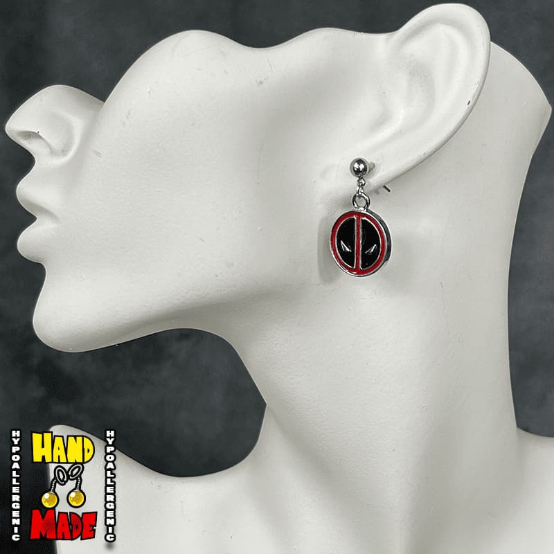Handmade Masked Mercenary Anime Earrings featuring metal mask charms with silver dropped post earrings.