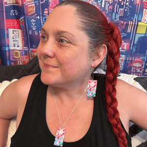 Model wearing the Acrylic Cherry Blossom Hanafuda Anime Necklace, featuring a pink cherry blossom acrylic charm on a silver chain.