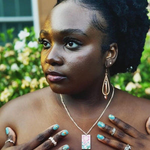Model wearing the Metal Cherry Blossom Hanafuda Anime Necklace, featuring a polished cherry blossom pendant and rose gold chain resting on the neckline.