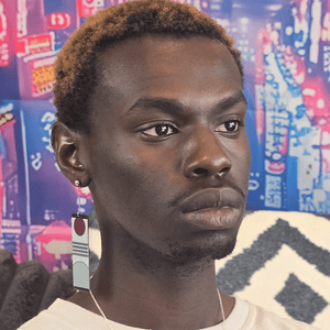 Model image of the hanafuda style earring with a rising sun above three horizontal gray stripes on a light gray background. Gray hilside at the bottom of the earring. Black bars border the top and bottom. Paired with silver jewelry extender and silver dropped posts.