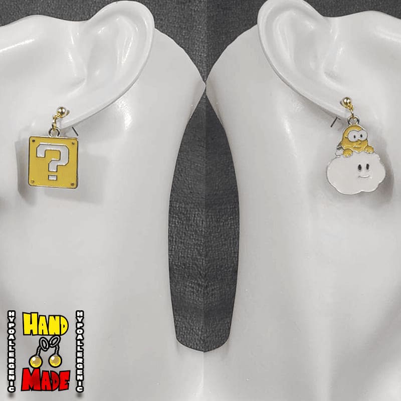 A pair of handmade earrings featuring a gold-colored question box and a white cloud charm, displayed on an ear mannequin.